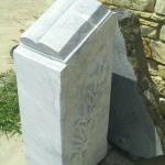 Limestone open book monument on "podium" with palm branches on each side. The stone is a very hard dolomitic limestone.